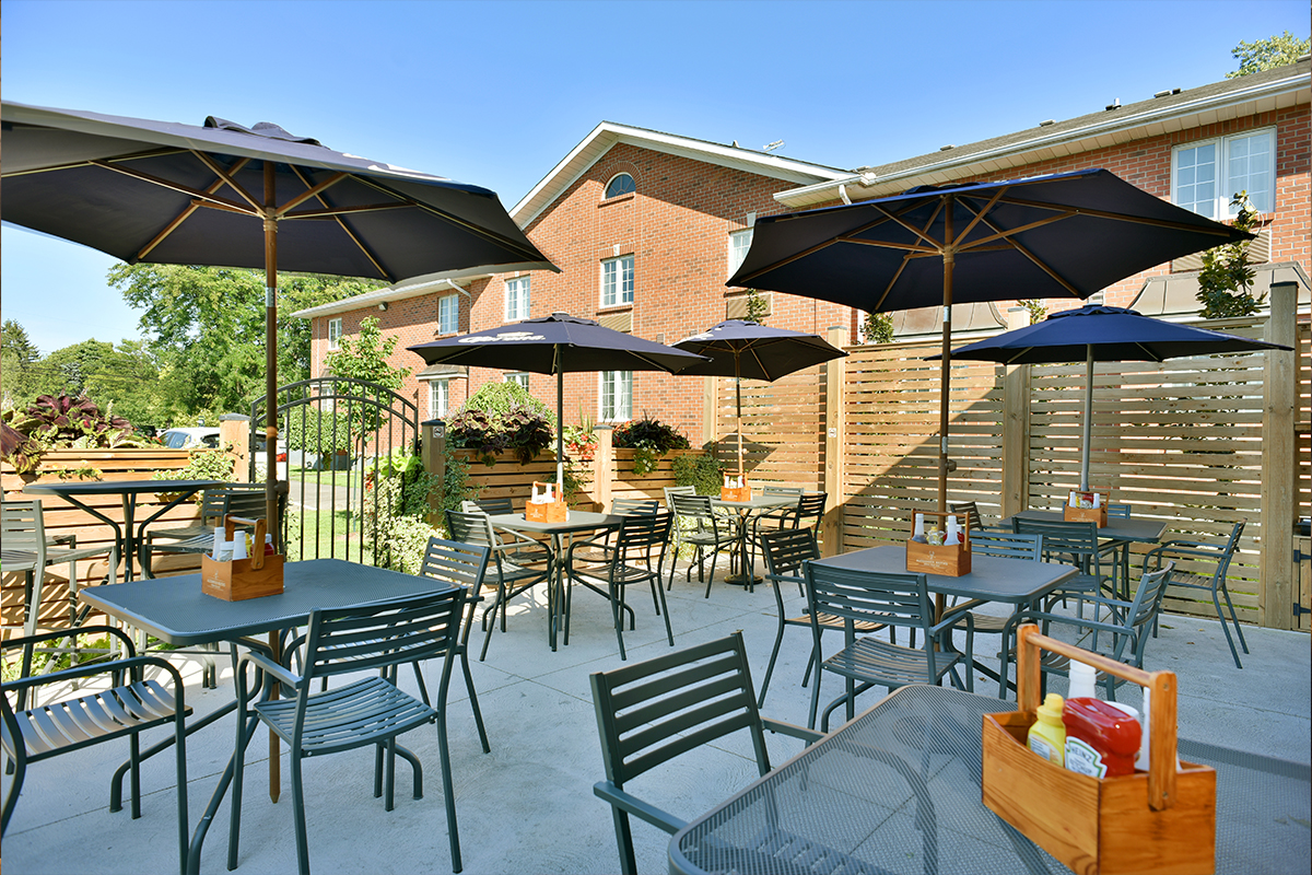 Butlers bar and grill outdor patio in Niagara on the Lake with tables and umbrellas